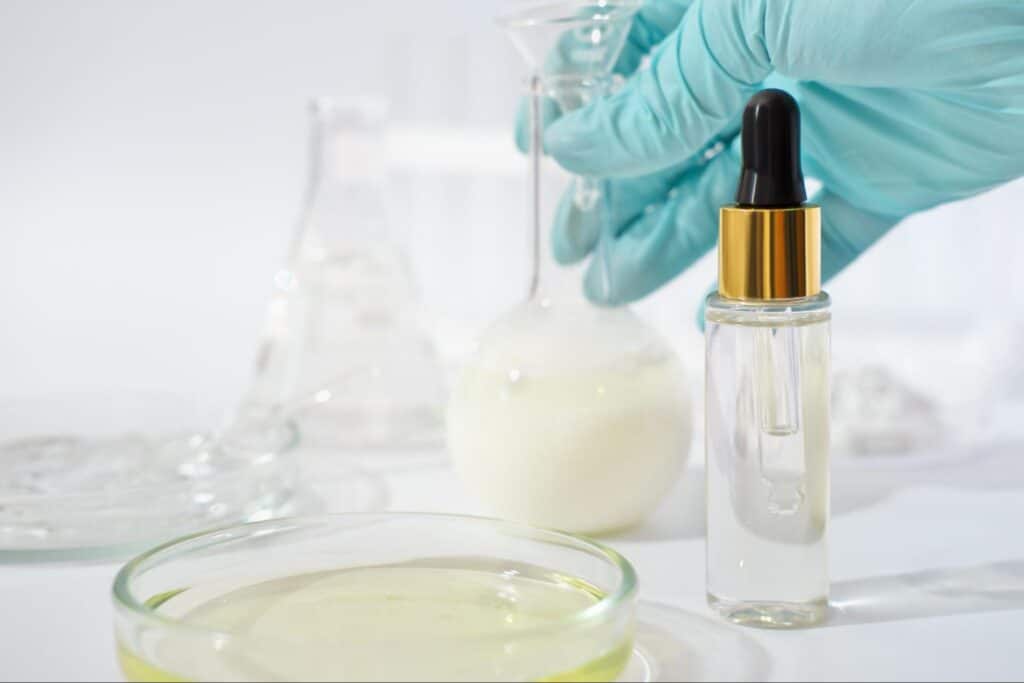 Lab experiment in progress with glassware and a dropper bottle.