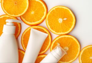Refreshing skincare products surrounded by vibrant orange slices for a citrus-infused glow.