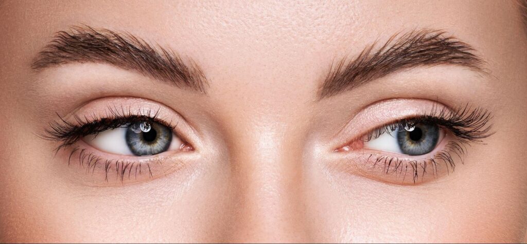 Close-up of mesmerizing blue eyes and elegantly shaped eyebrows for beauty tips.