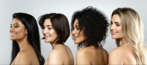 Women celebrating diverse hairstyles and textures in a beautiful group portrait.
