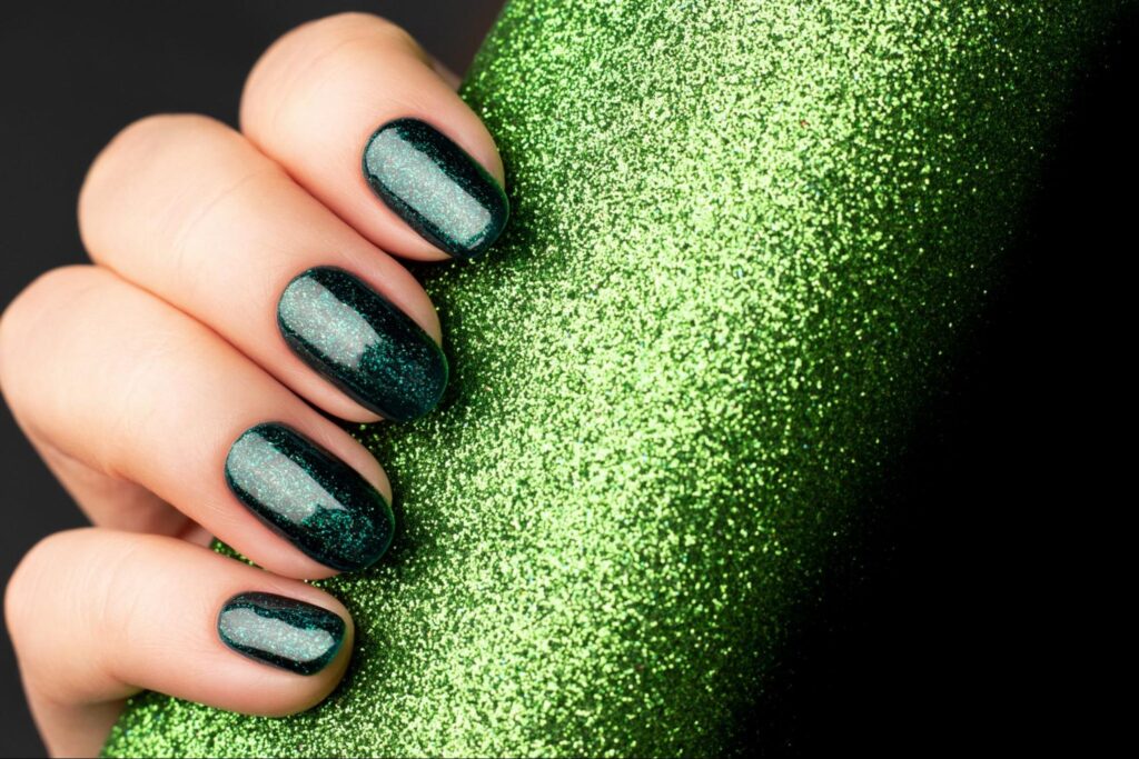 Glittering emerald nail art with a stunning shine on elegant fingers.
