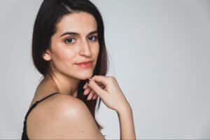 Confident woman with modern style, showcasing her striking features and poise.