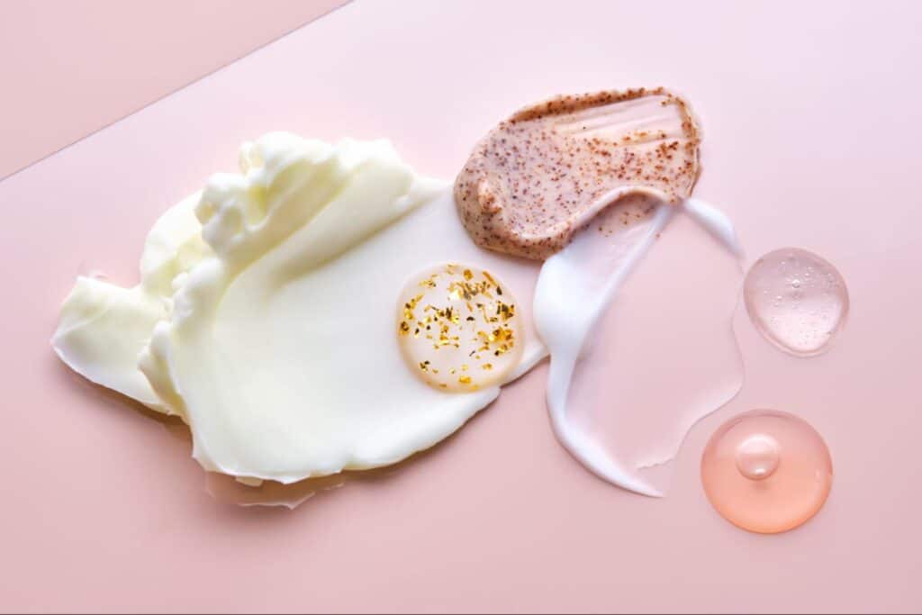 Luxury skincare textures for glowing, radiant skin on a soft pink backdrop.